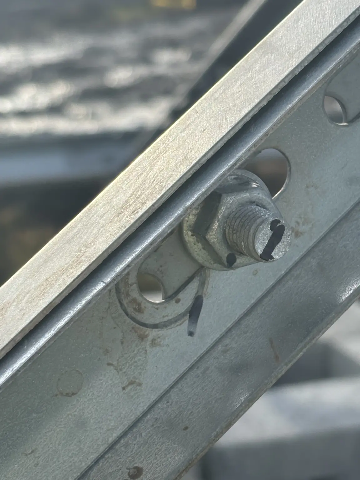 Close-up of galvanized solar mounting hardware with torque witness marks